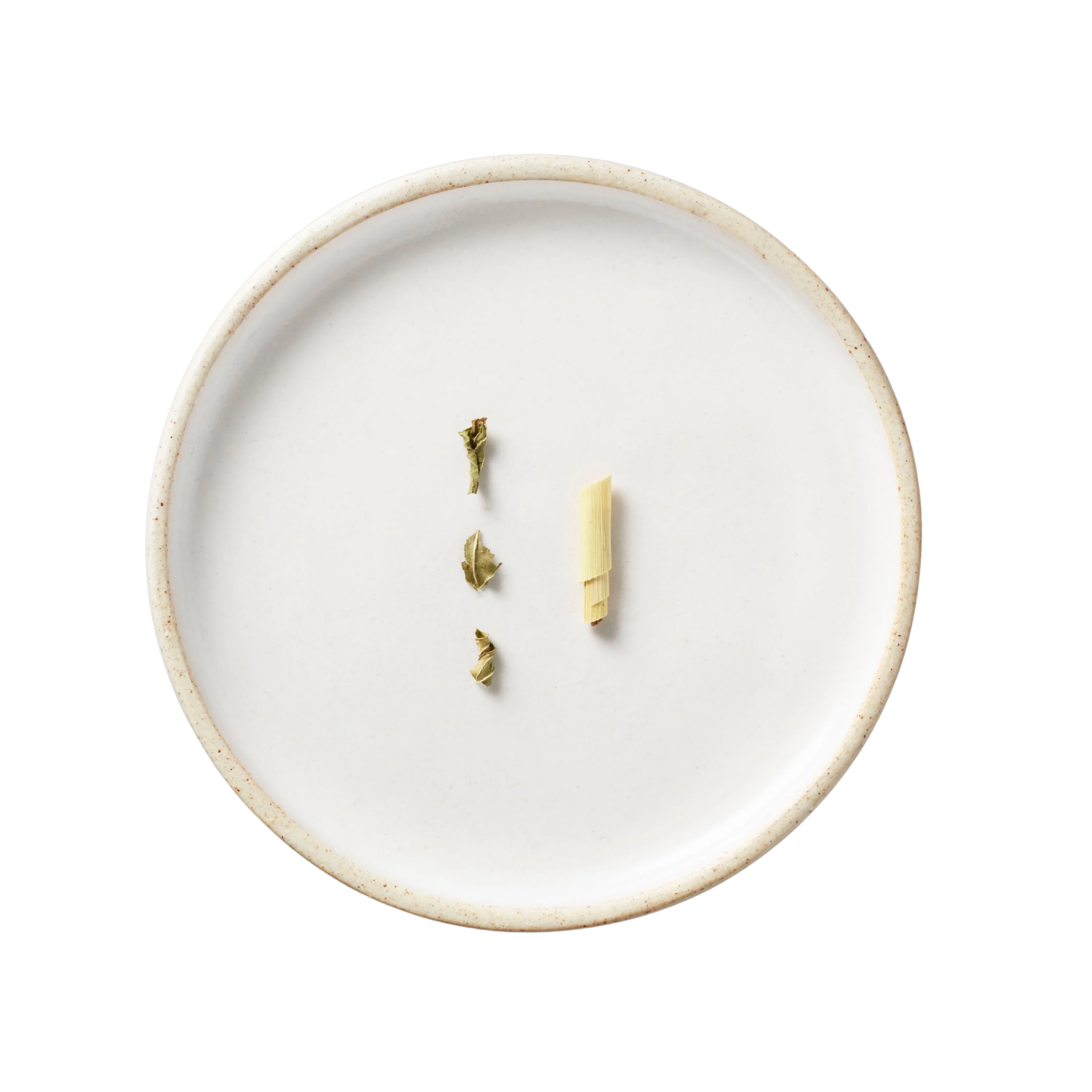 Rainier Tisane Blend: Minimalist display of lemongrass and dried leaves on a white ceramic plate, emphasizing the blend's organic ingredients and Pacific Northwest terroir.
