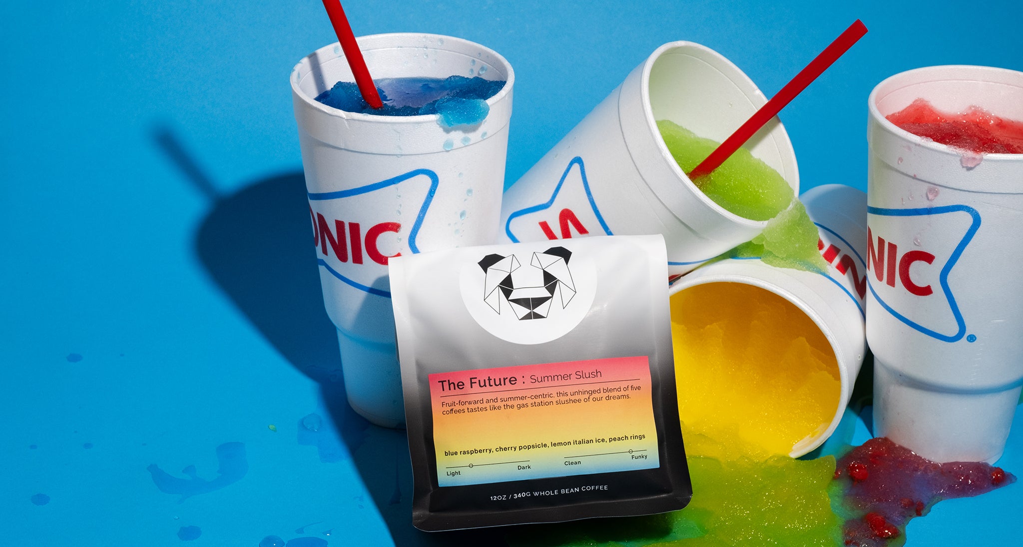 Slushy cups with different colors spilling out on a backdrop with a coffee bag that says The future Summer Slush.