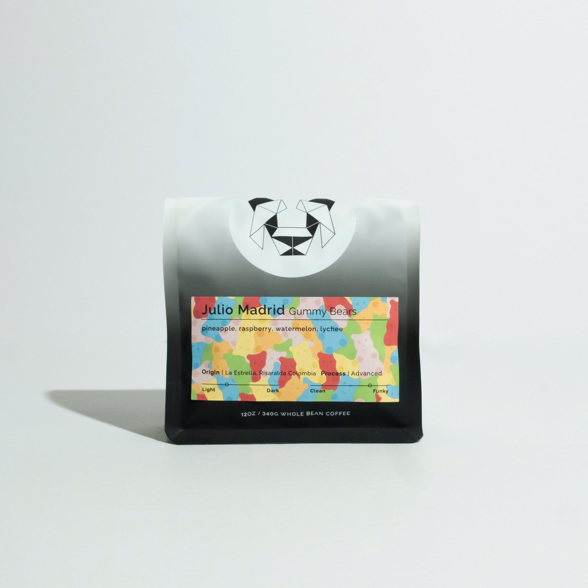 Matte-black coffee bag with geometric bear logo and colorful label reading Julio Madrid - Gummy Bears, featuring tasting notes of pineapple, raspberry, watermelon, and lychee.
