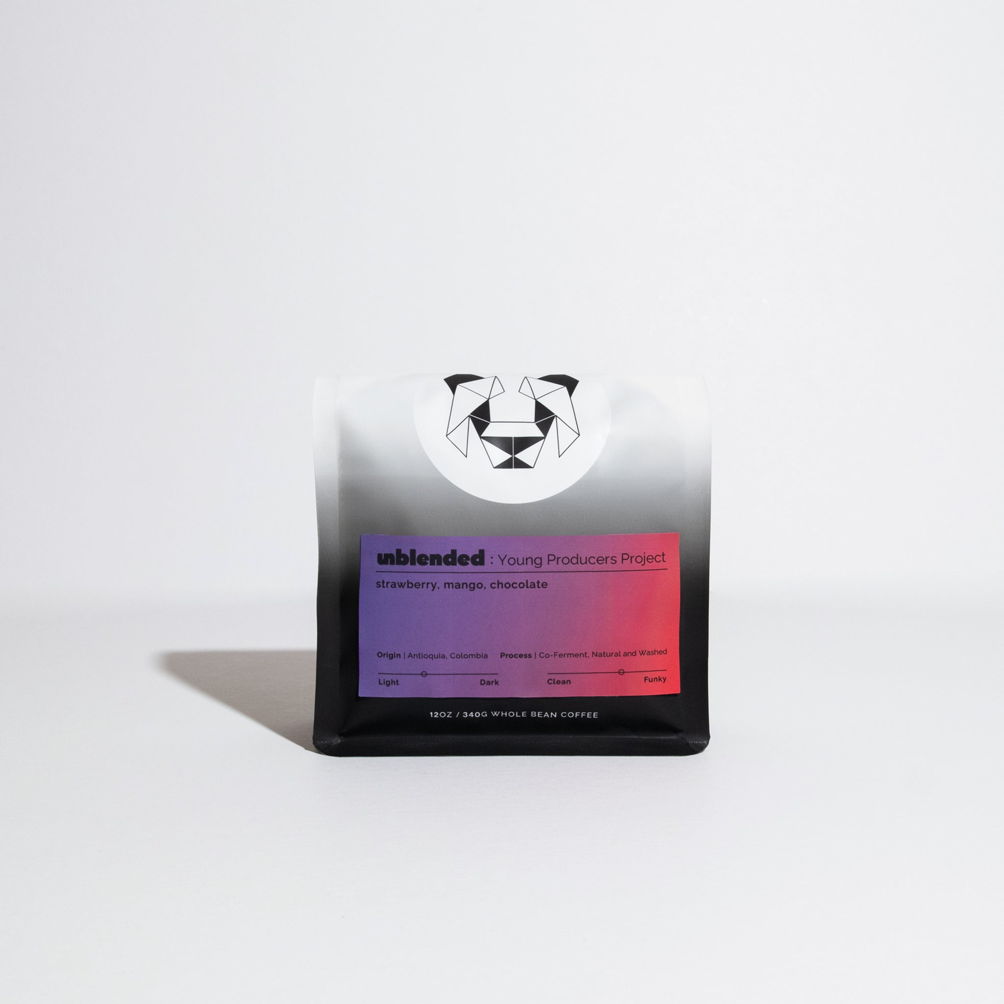 12 oz bag of Unblended Young Producers Project whole-bean coffee, featuring a panda logo, highlighting strawberry, mango, and chocolate notes. Origin: Antioquia, Colombia.