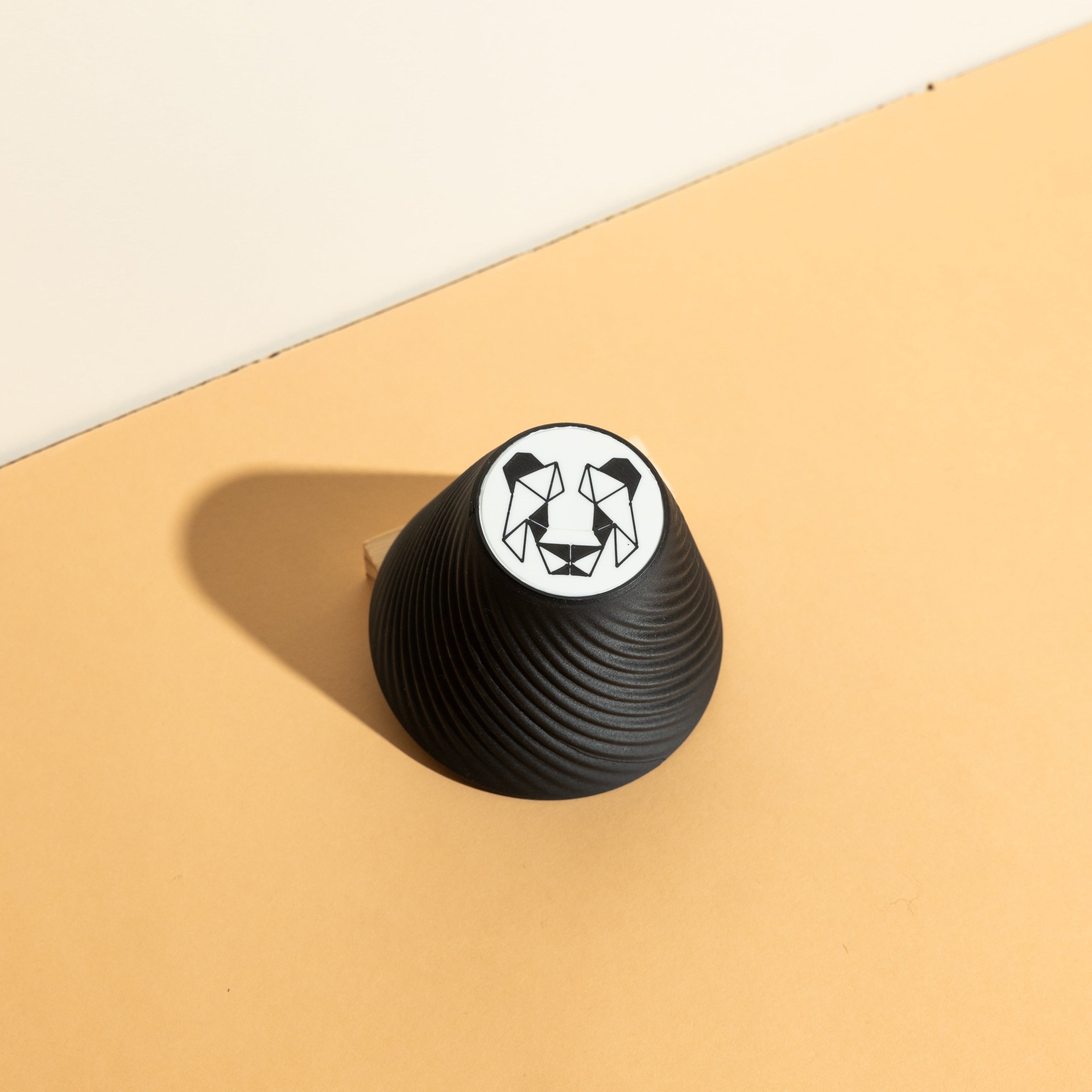 Pandagotiator accessory alongside Orea V3 dripper, emphasizing precision in coffee brewing with a compact, intricately designed tool for consistent filter folding.